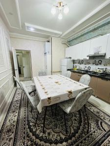 a kitchen with a table and chairs in a room at ЖК 2 Keruen Saray in Türkistan