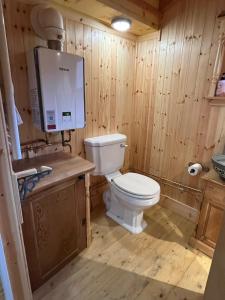 a bathroom with a toilet in a wooden room at Mòr Braw in Banavie