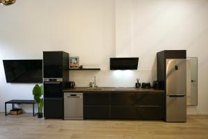 a kitchen with a stainless steel refrigerator and a sink at Cliff Appart in Valencia