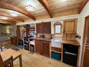 a kitchen with wooden cabinets and a table in a room at Mòr Braw in Banavie +17 photos