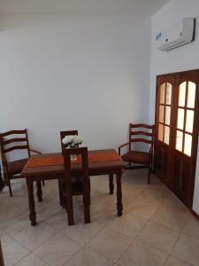 a dining room with a table and chairs at Two Bedroom Condo, Mindelo in Mindelo +11 photos