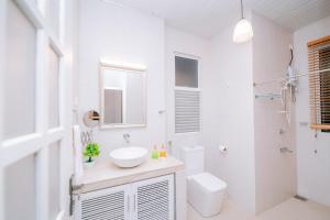 a white bathroom with a sink and a toilet at Heaven R in Kandy +14 photos