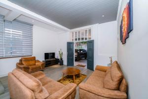 a living room with two couches and a tv at Heaven R in Kandy