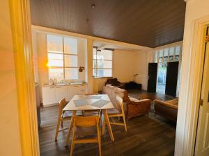 a kitchen and living room with a table and chairs at Heaven R in Kandy
