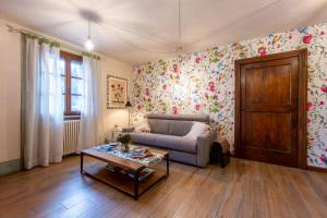 a living room with a couch and a table at Villa Rosmarino in Imperia