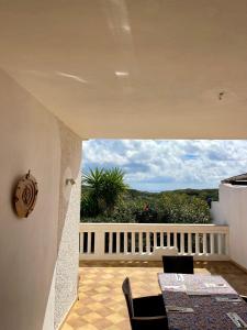 a dining room with a view of a balcony at Casa Franco in Lampedusa +5 photos