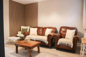 a living room with a couch and two chairs at Britannia Lodge in Howden