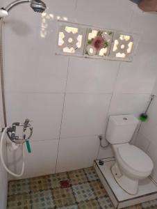 a bathroom with a toilet and a shower at Cemara Paradise Homestay in Pulau Gilimelayu +41 photos
