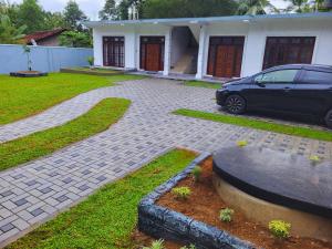 a car parked in front of a house at Nimsara Homes in Veyangoda