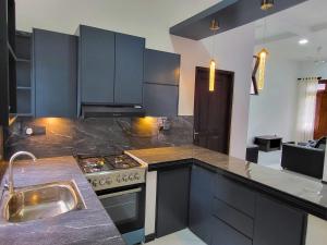 a kitchen with a stove and a counter top at Nimsara Homes in Veyangoda