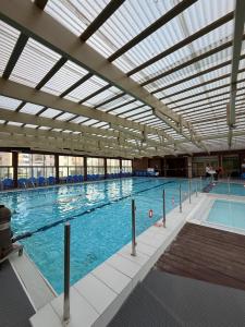 a large indoor swimming pool with a large ceiling at Sunset Suite sea&sky in Ashkelon