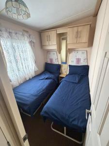 a small room with two beds in it at seton sands caravan in Port Seton