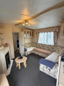 a living room with a couch and a table at seton sands caravan in Port Seton