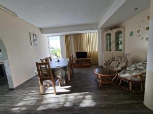 a living room with a table and chairs and a couch at Appartment Camellia in Flic-en-Flac