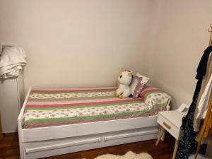 a teddy bear sitting on a bed in a bedroom at Refugio de ensueño in Sabiñánigo