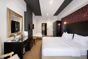 a hotel room with a large bed and a sink at Areos in Athens +51 photos
