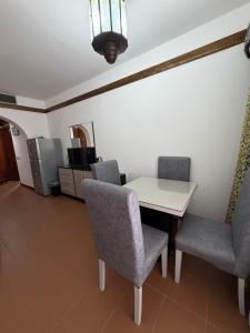 a dining room with a white table and chairs at Private one-unit in Domina coral bay Beach and lake direct view 3 in Sharm El Sheikh +4 photos