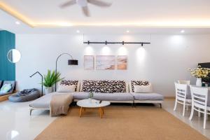 a living room with a couch and a table at Kozy Home Apartment in Vung Tau - Tam Thang Tower View & Back Beach step away in Vung Tau