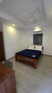a bedroom with a large bed in a room at Mansori Residency in Cochin