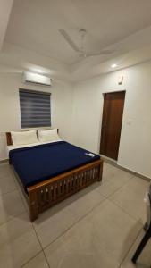 a bedroom with a large bed in a room at Mansori Residency in Cochin