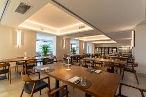 a dining room with wooden tables and chairs at Aldero Hotel in Civita Castellana