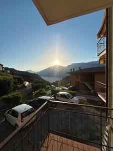 a view of a mountain with cars parked on a balcony at Casa Diana - Panoramablick auf den Gardasee in Pieve