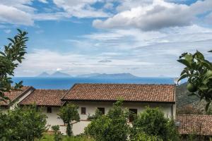 a house with a view of the ocean and mountains at Villa Rica in Patti