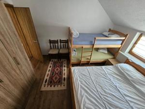 a small room with a bed and two bunk beds at Villa Fresku in Peje