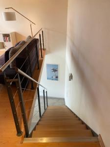 a staircase leading up to a room with a bed at Ferienwohnung Red Horse Ranch in Eichstätt