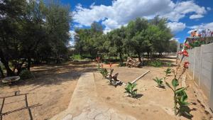 a garden with some flowers in the dirt at Charlen's Rest in Windhoek