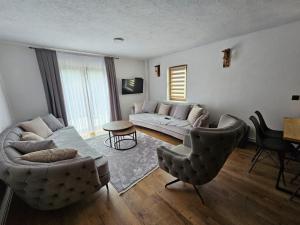 a living room with a couch and two chairs at Villa Fresku in Peje