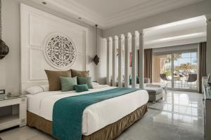 a bedroom with a large bed and a living room at Grand Palace - Couples only 18 years plus in Hurghada