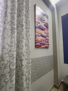 a room with a curtain and a painting on the wall at 5 cupole in Palermo +46 photos