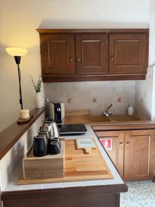 a kitchen with a counter with pots and pans on it at La Piazzetta Apartment in Pietralunga