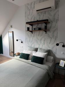 a bedroom with a large bed and a mirror at Sylina Spa avec Jacuzzi Privé in Villeblevin