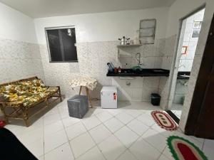 a living room with a couch and a kitchen at Apto 04 em São Bras in Belém +4 photos