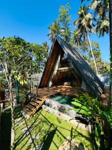 a small house with a pool in the yard at Ceylon Canopy in Hiriketiya