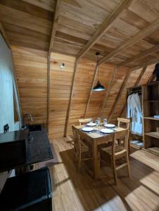 a wooden dining room with a table and chairs at Ceylon Canopy in Hiriketiya