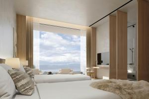 a bedroom with two beds and a large window at The Dali EDITION in Dali +68 photos