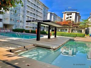 a swimming pool in front of a building at R&N Trees Residence in Manila