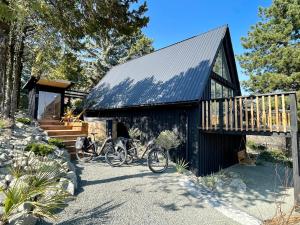 two bikes parked in front of a black barn at Black Pine Cabin in Szentendre
