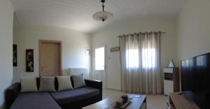 a living room with a couch and a table at Vacation Home in Myrina