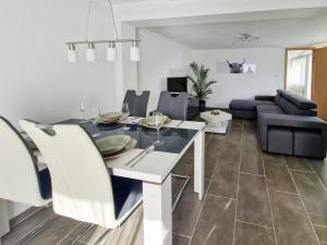 a living room with a table and a couch at Chalet Bellevue Beautiful Waterfall view private Garden & free parking in Lauterbrunnen