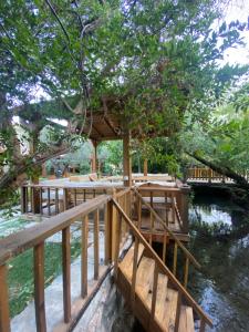 a tree house with a deck in the water at Pavelin yeri in Altınoluk +9 photos