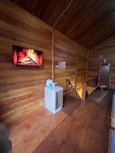 an overhead view of a room with a fireplace and a tv at Cabin Hillside Dieng in Diyeng