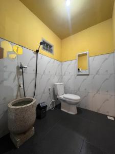 a bathroom with a toilet and a shower in it at Cabin Hillside Dieng in Diyeng +36 photos