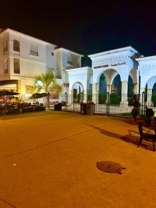 a white building with a fence in front of it at harhoura Résidence Badia in Temara +6 photos