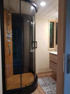 a glass shower in a bathroom with a sink at Le Riolet in Marsac-en-Livradois +14 photos