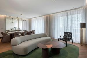 a living room with a couch and a dining room at The Landmark Nicosia, Autograph Collection in Nicosia