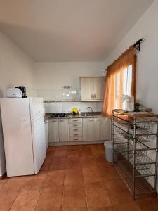 a kitchen with a white refrigerator and a window at Nature in Tejeda in Tejeda